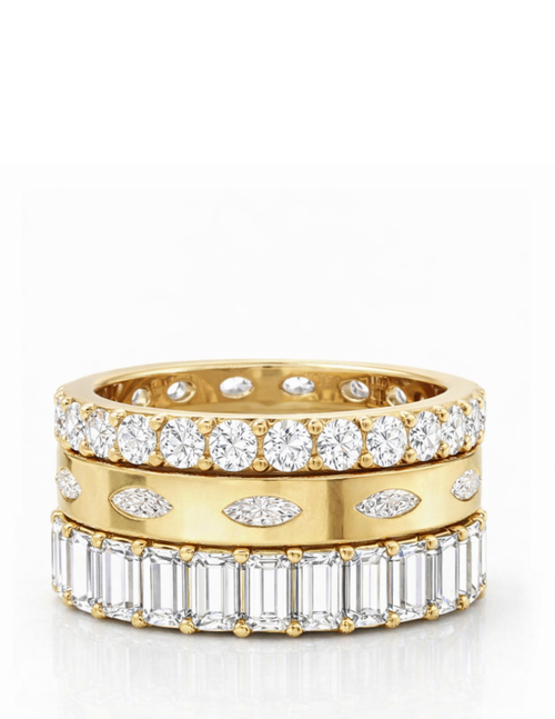 three gold and diamond rings on a white background