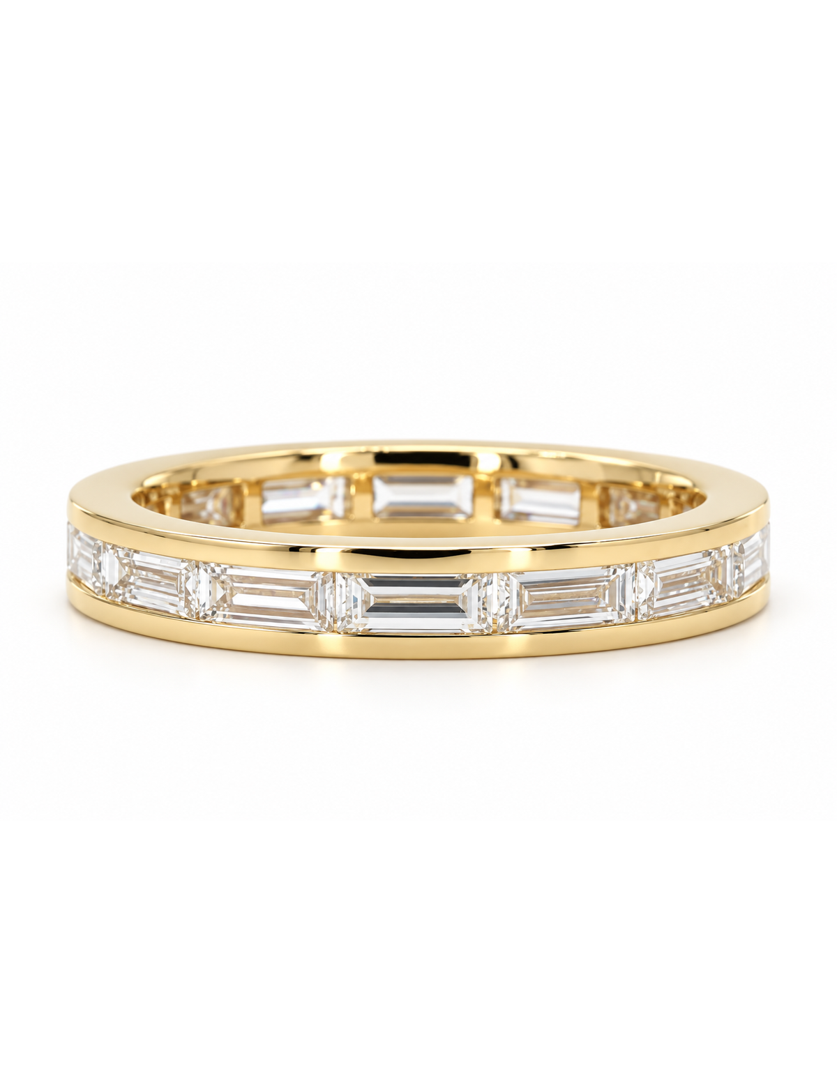 A yellow gold eternity ring featuring a continuous channel setting of baguette-cut clear stones, shown on a clean white background.