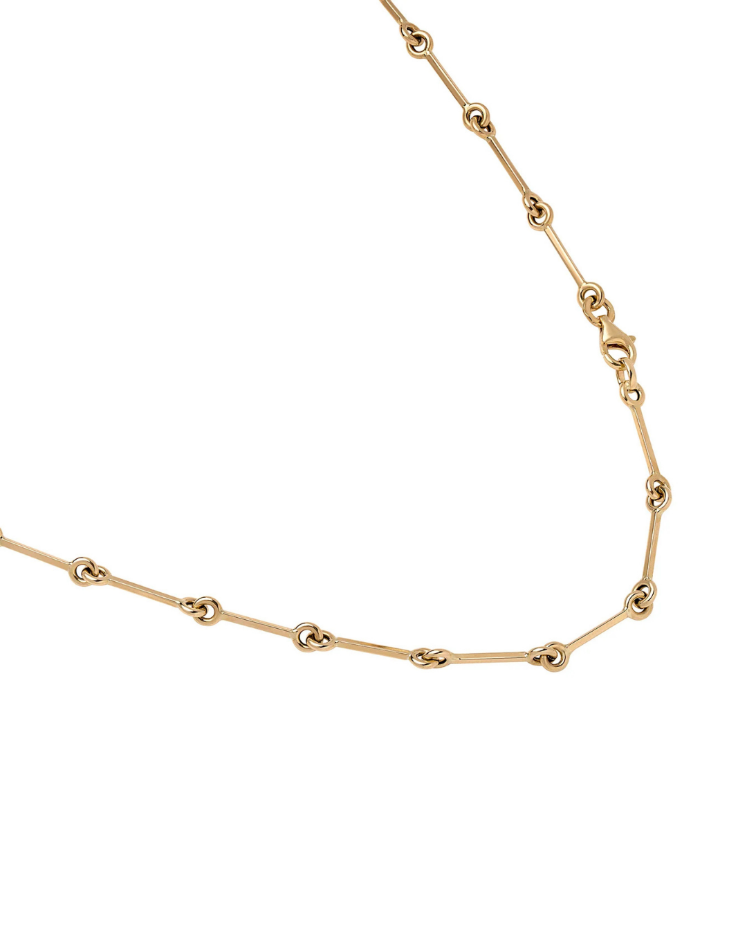 A close-up of a gold chain necklace featuring alternating elongated oval links and smaller circular links, shown against a plain white background.